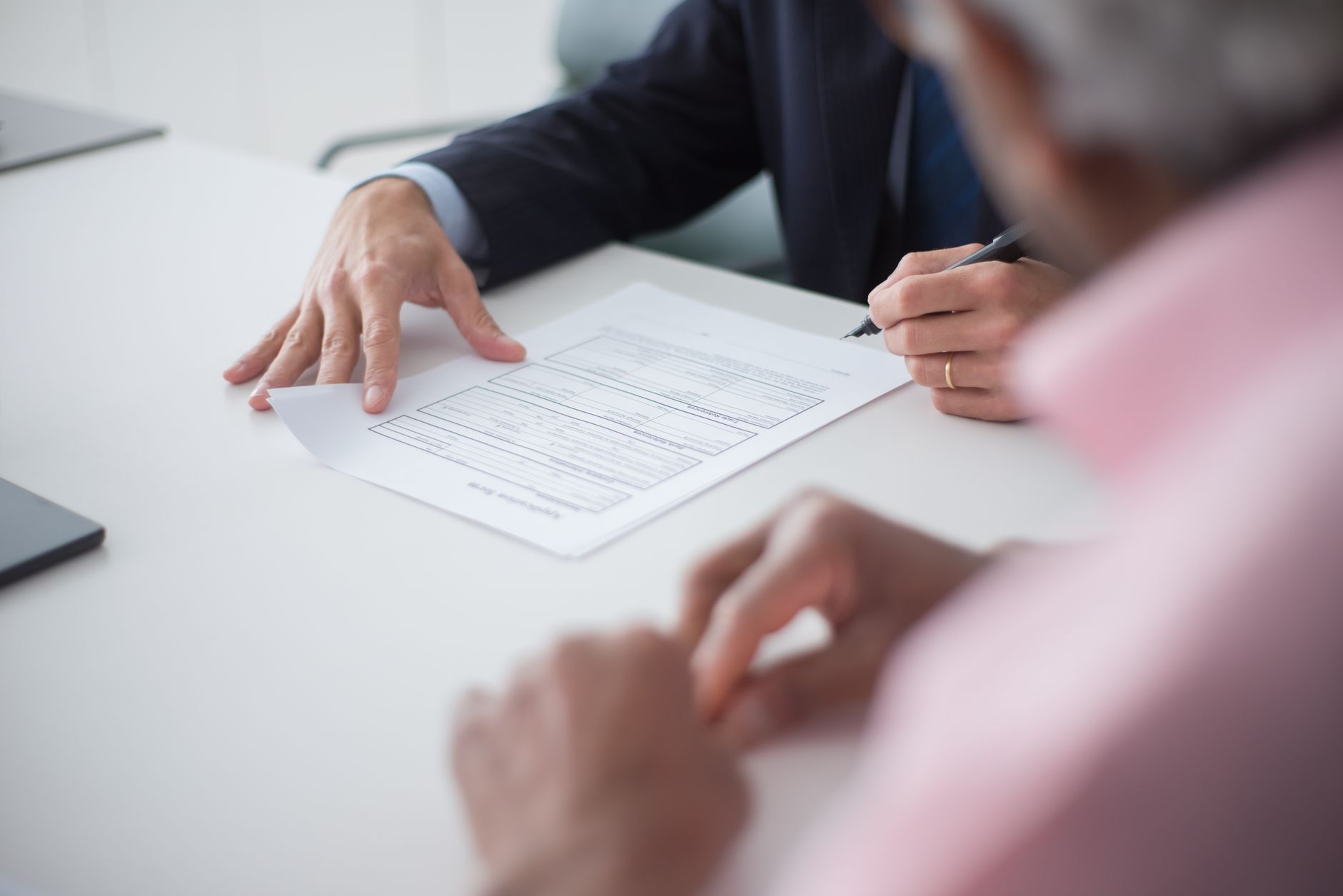 Professional signing business documents during a consultation
